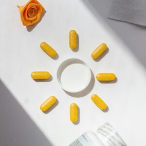 A bottle of pills and a rose on a table